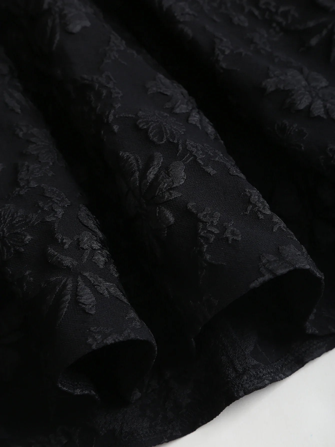 Black floral jacquard strapless dress with button embellishments and puff style skirt