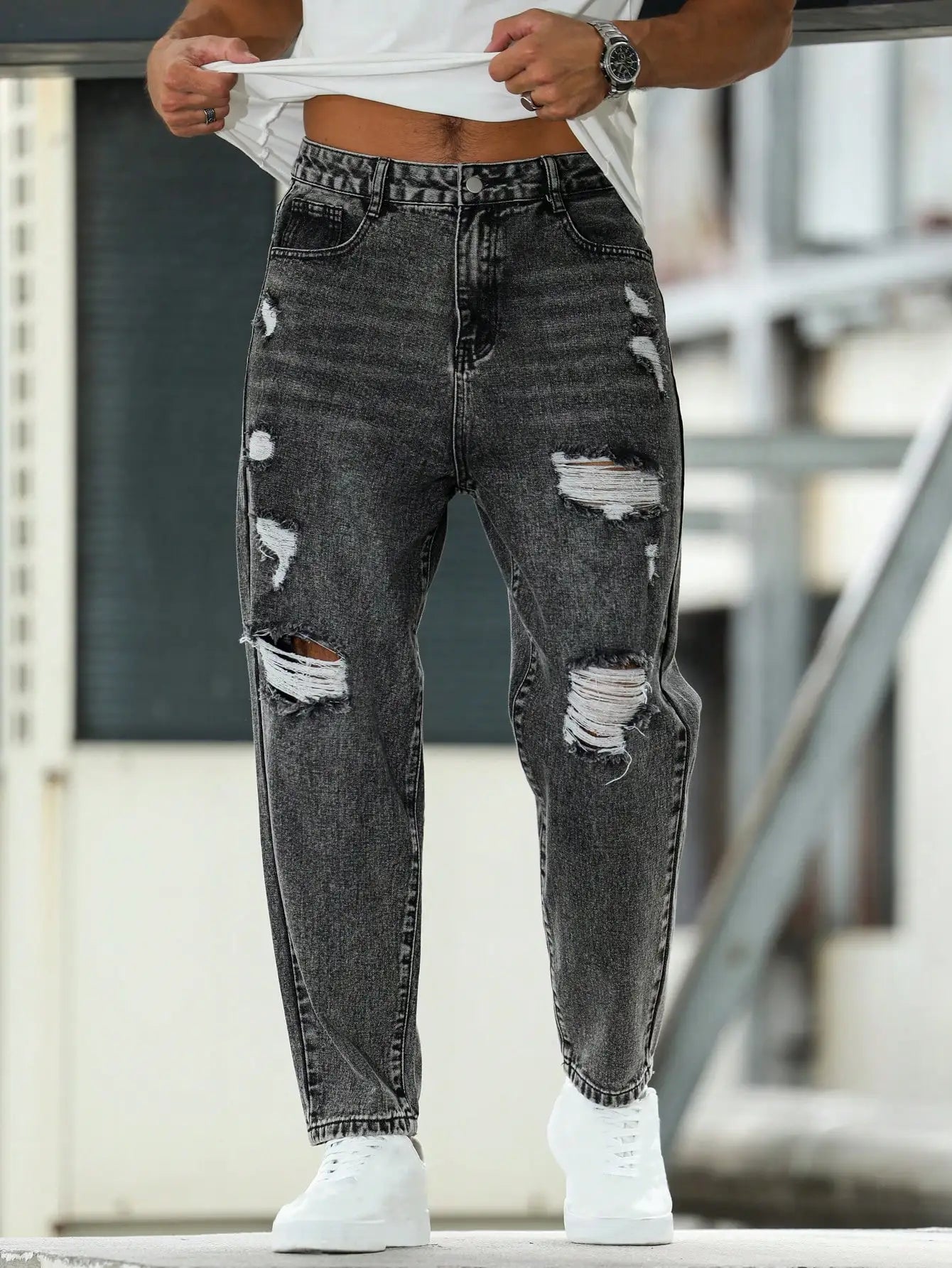 Men's ripped jeans for spring and autumn, dark gray harem pants. Street style. Casual trend.