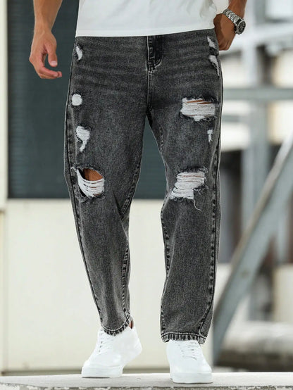 Men's ripped jeans for spring and autumn, dark gray harem pants. Street style. Casual trend.
