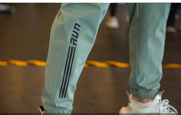 Mens Gym Fitness Running Sweatpants Workout Athletic Long Pants Outdoor Training Sports Trousers Elastic Waist Zipper Pockets