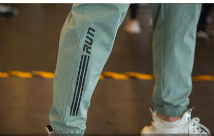 Mens Gym Fitness Running Sweatpants Workout Athletic Long Pants Outdoor Training Sports Trousers Elastic Waist Zipper Pockets