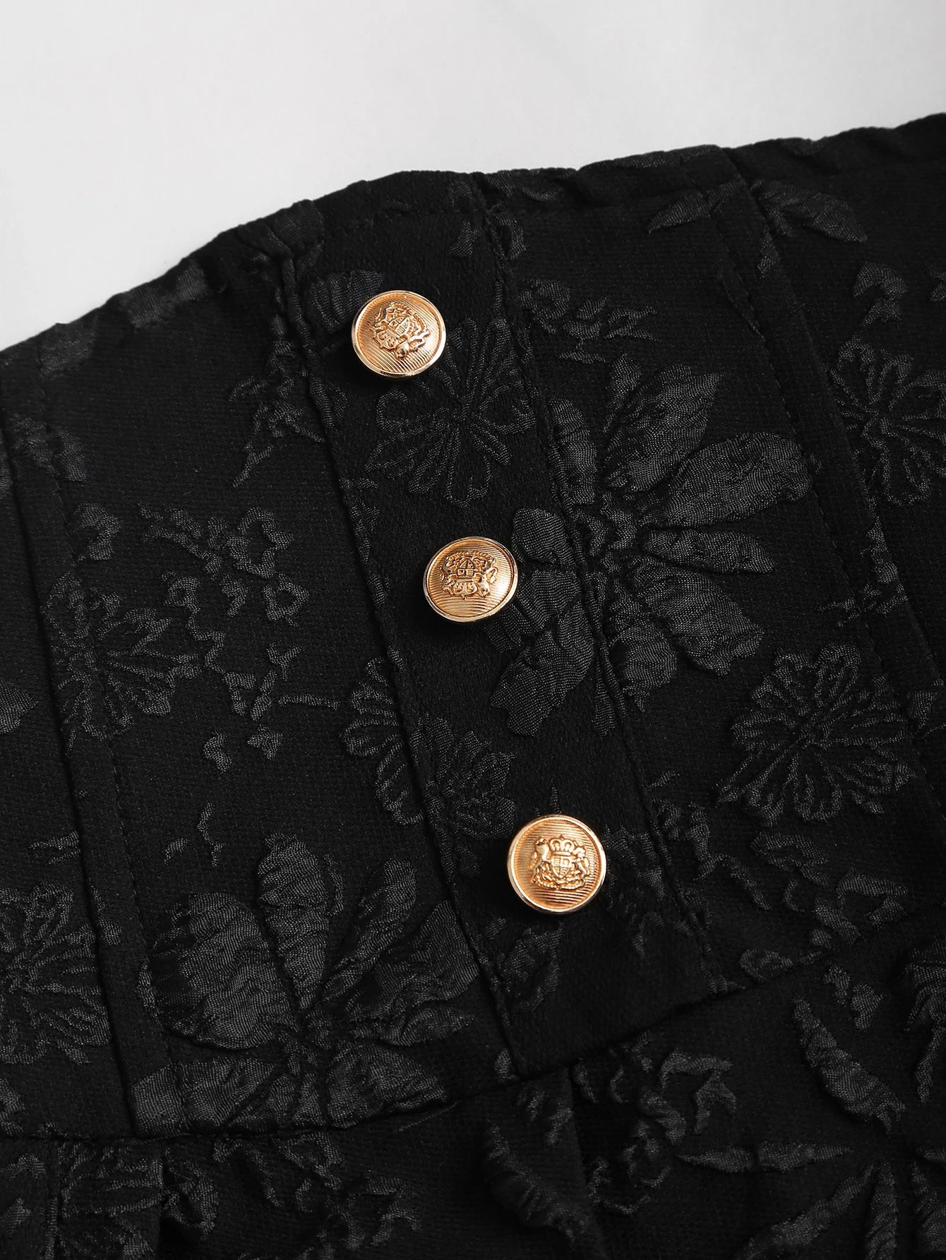 Black floral jacquard strapless dress with button embellishments and puff style skirt