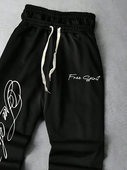 Men's Trendy Street-Style Ins High Street Black Faux Two-Piece Design Sweatpants with Unique Waistband and Ankle Zipper Details. It Is Perfect for Music Festival Outfits or Everyday Wear, Making It a Great Gift for Your Boyfr