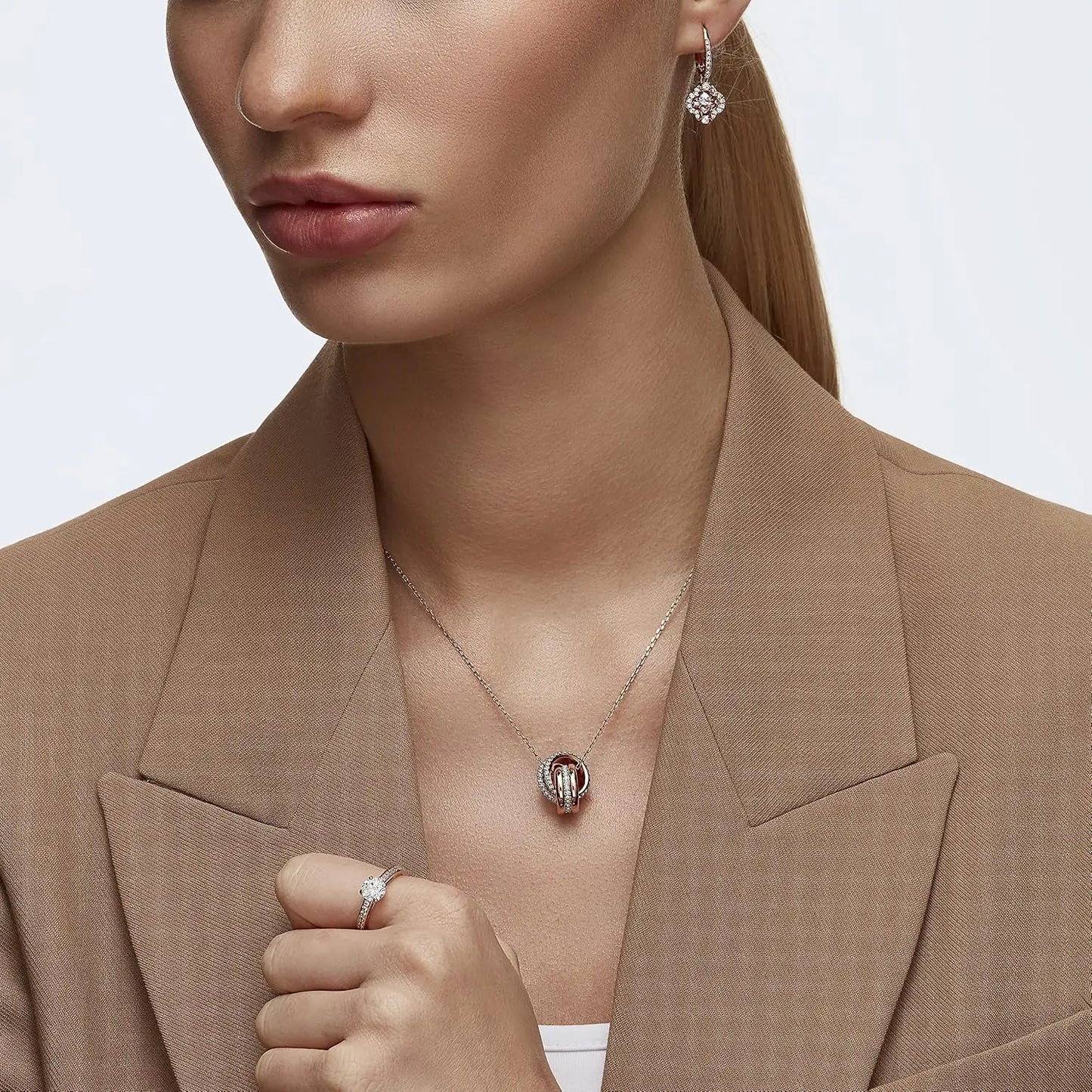 Una Pierced Earrings with Clear Crystal Pavé Surrounding a Pink Stone on a Rose-Gold Tone Finished Setting