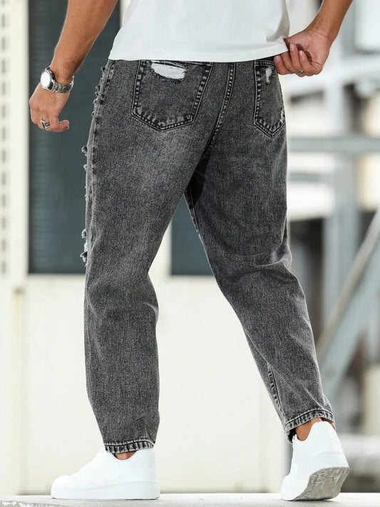 Men's ripped jeans for spring and autumn, dark gray harem pants. Street style. Casual trend.