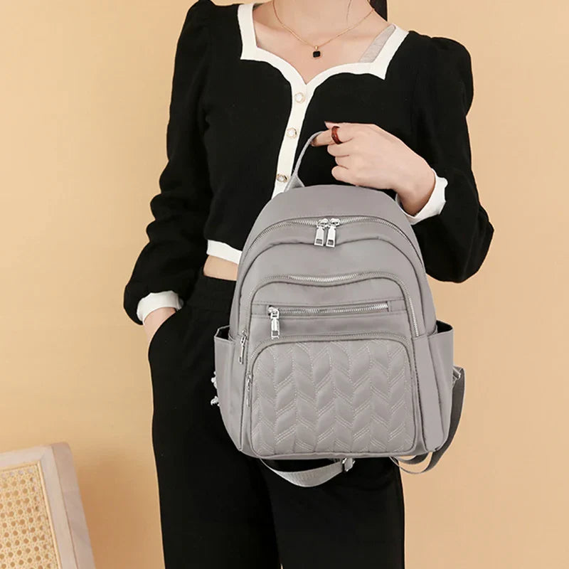 Men's and women's fashionable backpack made of nylon, suitable for travel, tourism and photography. It has multiple pockets.