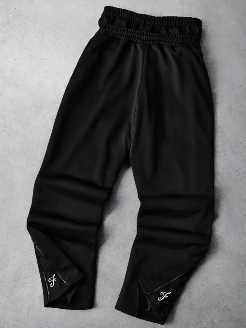 Men's Trendy Street-Style Ins High Street Black Faux Two-Piece Design Sweatpants with Unique Waistband and Ankle Zipper Details. It Is Perfect for Music Festival Outfits or Everyday Wear, Making It a Great Gift for Your Boyfr