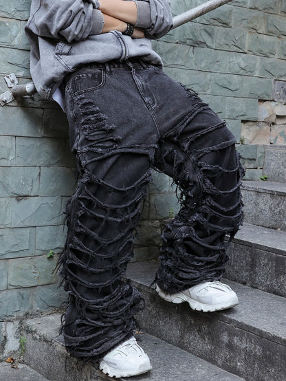 Men's black jeans. With a design of (ripped holes) and tassels. In a street trend style.