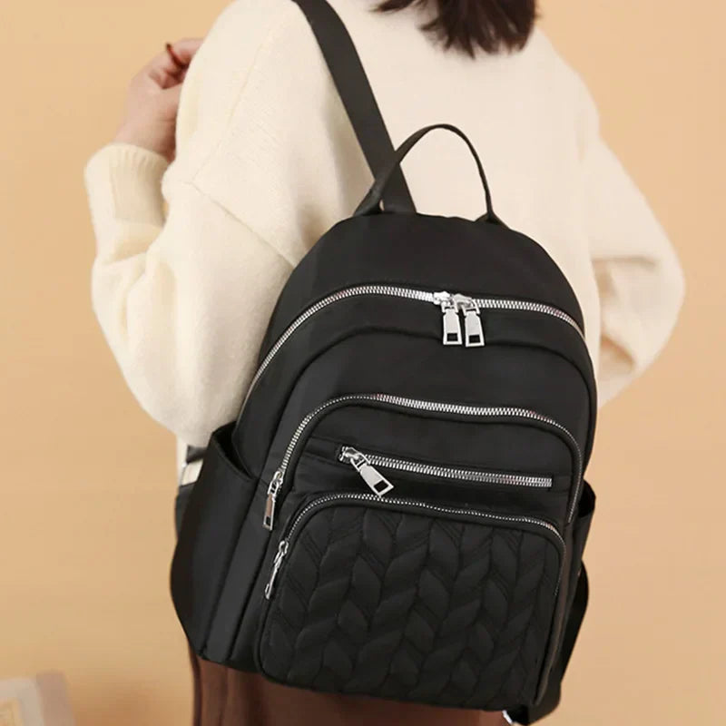 Men's and women's fashionable backpack made of nylon, suitable for travel, tourism and photography. It has multiple pockets.