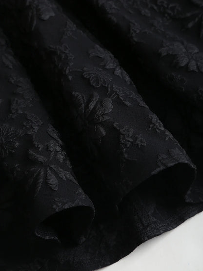 Black floral jacquard strapless dress with button embellishments and puff style skirt