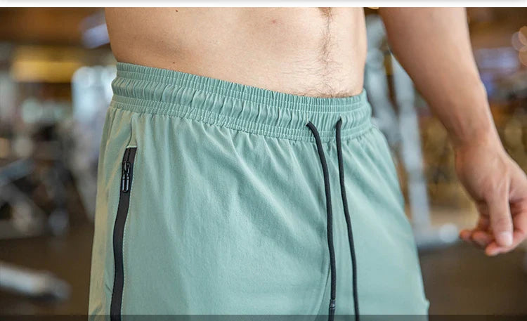 Mens Gym Fitness Running Sweatpants Workout Athletic Long Pants Outdoor Training Sports Trousers Elastic Waist Zipper Pockets