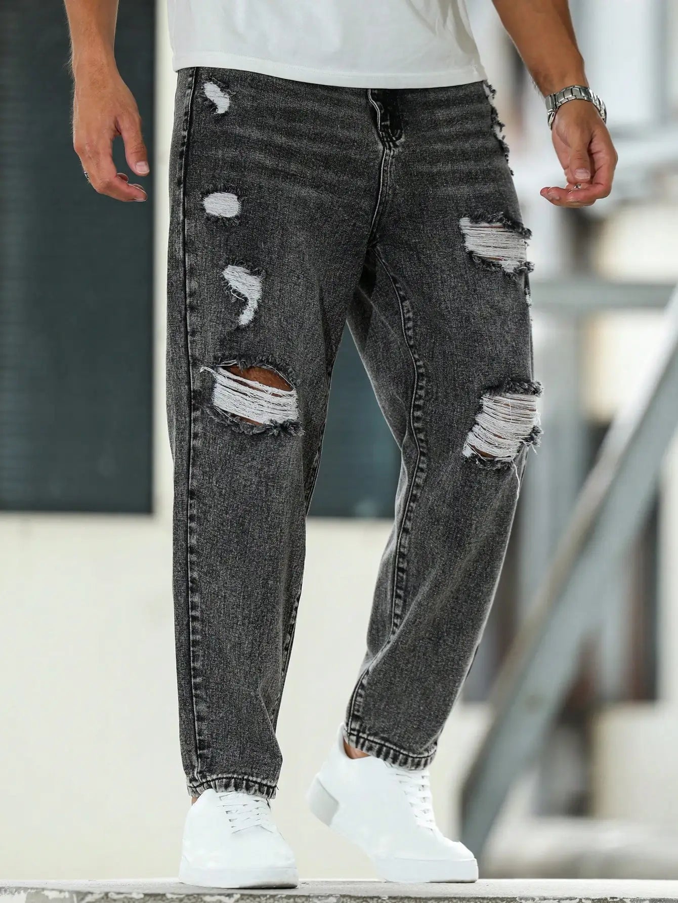 Men's ripped jeans for spring and autumn, dark gray harem pants. Street style. Casual trend.