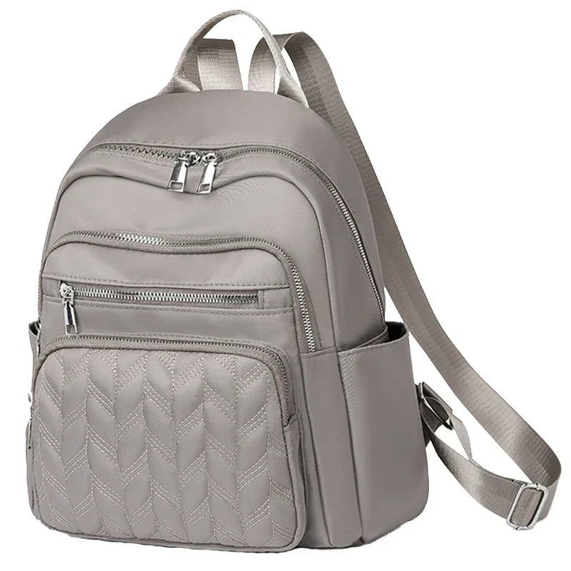 Men's and women's fashionable backpack made of nylon, suitable for travel, tourism and photography. It has multiple pockets.