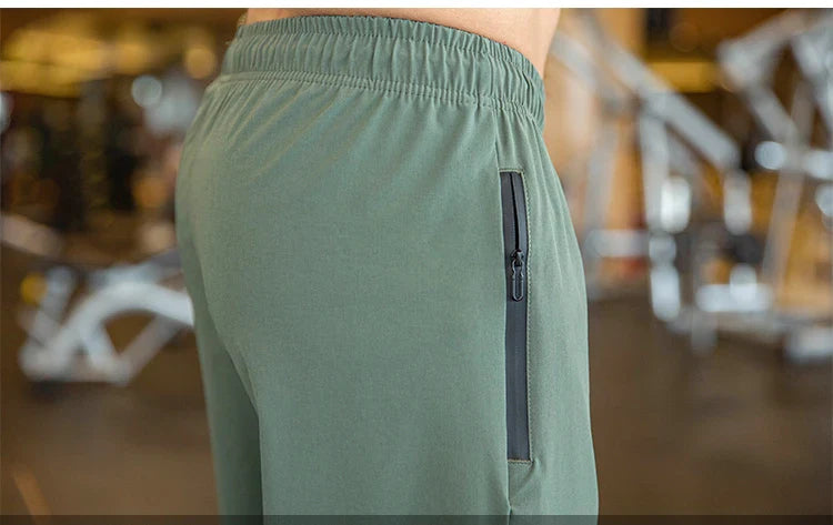 Mens Gym Fitness Running Sweatpants Workout Athletic Long Pants Outdoor Training Sports Trousers Elastic Waist Zipper Pockets