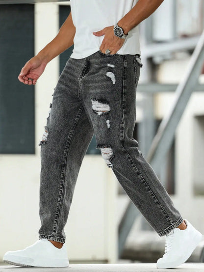 Men's ripped jeans for spring and autumn, dark gray harem pants. Street style. Casual trend.